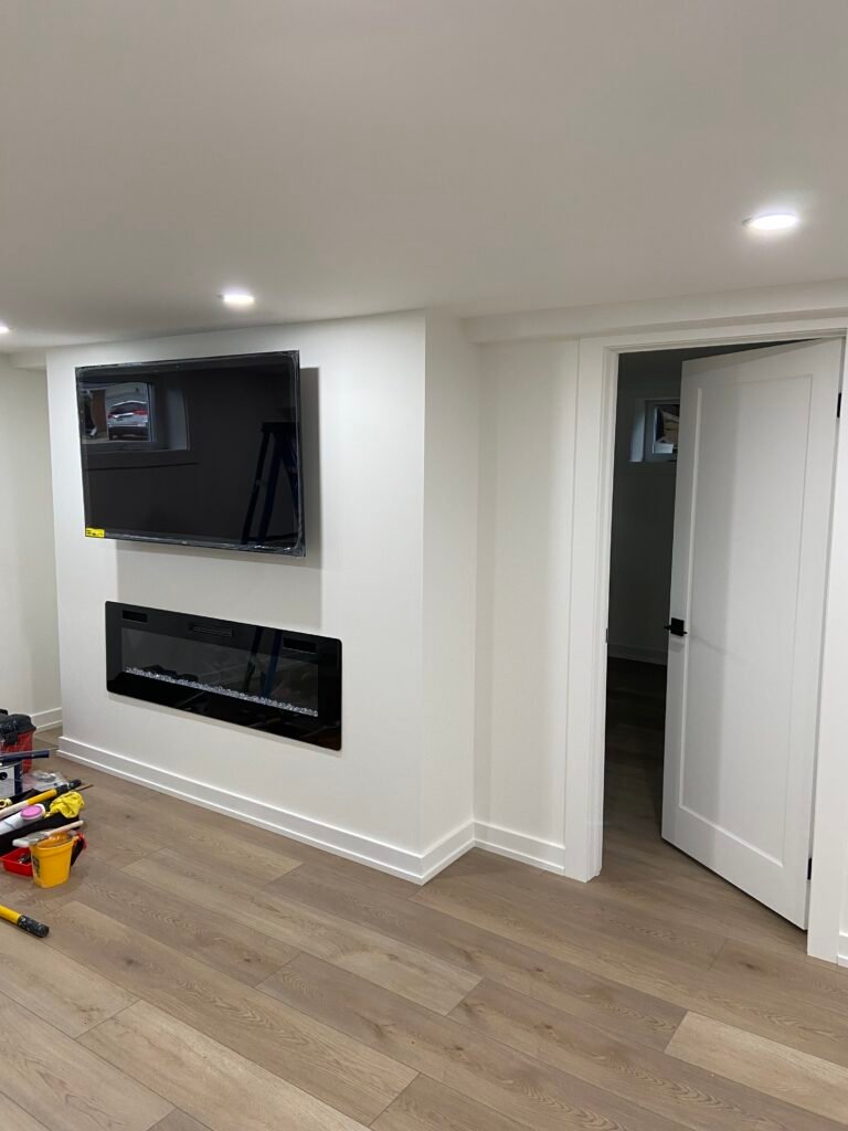 Finished basement with fireplace wall