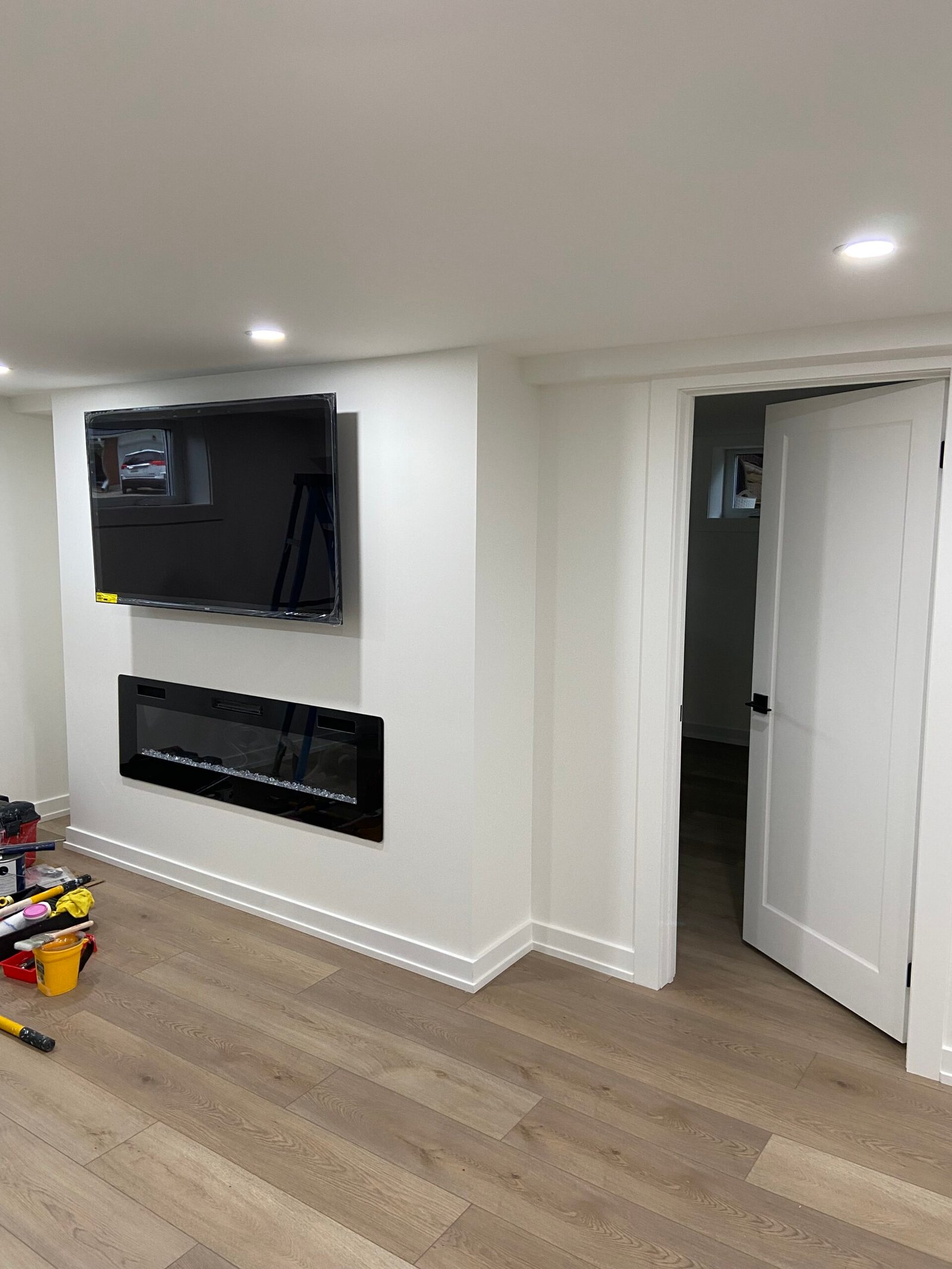 Finished basement with fireplace wall